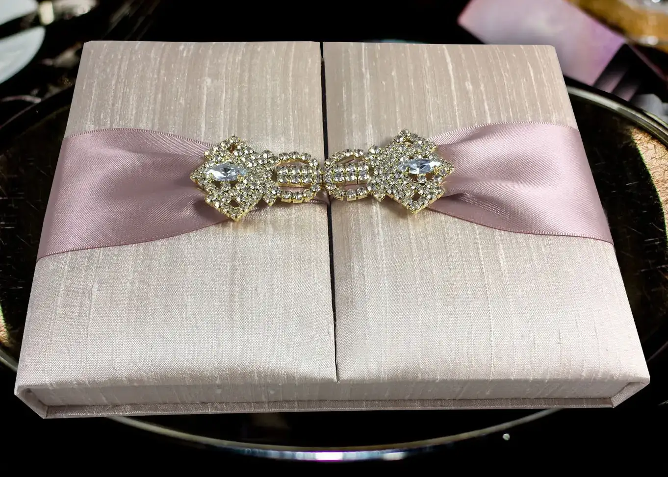 Luxury boxed wedding invitation featuring Thai silk and rhinestone clasp from Prestige Creations